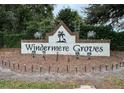 Community sign for Windermere Groves subdivision with festive holiday decorations at 807 Grovesmere Loop, Ocoee, FL 34761