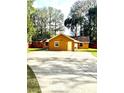 Charming single-story home featuring a concrete driveway and mature trees in a serene setting at 12139 Palmetto Way, Dunnellon, FL 34432