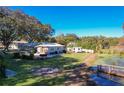Charming home with a spacious yard, patio, storage shed, and dock access to a serene pond at 1405 Spring Lake Ter, Ocoee, FL 34761