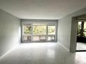 Bright living room with large windows providing ample natural light and scenic views at 5789 Windhover Dr # E03, Orlando, FL 32819