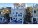 Three stories of balconies with white railings offer outdoor living and views at 7405 Excitement Dr, Kissimmee, FL 34747