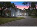 Beautiful two-story home with stone and stucco exterior and a paved driveway leading to the entrance at 1003 Oakdale St, Windermere, FL 34786