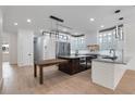 Modern kitchen with white cabinets, stainless steel appliances, granite countertops, and center island at 1003 Oakdale St, Windermere, FL 34786