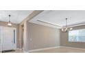 Inviting entryway with tiled floors and decorative lighting fixture at 4363 Summer Breeze Way, Kissimmee, FL 34744