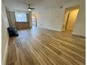 Bright living room with wood-look tile floors, ceiling fan, and natural light from the window at 1234 Sago Palm Blvd # 1234, Kissimmee, FL 34741