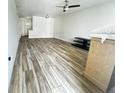 Open-concept living room with wood-look tile, light walls, and lots of natural light at 1234 Sago Palm Blvd # 1234, Kissimmee, FL 34741