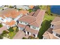 Aerial view of a two-story home featuring a tiled roof, well maintained lawn, and attached two car garage at 13333 Oakenshaw Ln, Orlando, FL 32832
