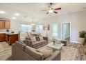 Bright living room with open floor plan, hardwood floors, and stylish furniture at 548 Coral Trace Blvd, Edgewater, FL 32132