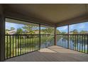 Enjoy the beautiful lake view from this screened in porch with wood floors and black railing at 5929 Windhover Dr # A02, Orlando, FL 32819