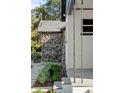 Home exterior featuring a stone accent wall and lush landscaping at 400 Raehn St, Orlando, FL 32806