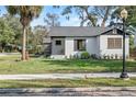 Renovated white brick home with a gray roof and manicured lawn at 400 Raehn St, Orlando, FL 32806
