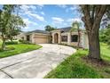 Charming single-story home boasting a circular driveway and beautifully landscaped front yard at 6689 Bell Glade Pl, Sanford, FL 32771