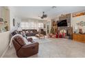 Spacious living room with a fireplace, comfortable furniture, and large windows at 6689 Bell Glade Pl, Sanford, FL 32771