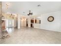 Open concept living room with tile flooring, a brick fireplace, and views of the kitchen and entry at 6689 Bell Glade Pl, Sanford, FL 32771
