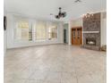 Spacious living room featuring a brick fireplace and large windows with plantation shutters at 6689 Bell Glade Pl, Sanford, FL 32771