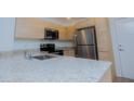 Modern kitchen featuring stainless steel appliances and granite countertops at 1210 Southstation Pl # 303, Orlando, FL 32809
