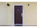 Condo front entrance with brown door and black knocker at 411 Lucaya Loop # 411, Davenport, FL 33897