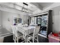 Dining area with white table and chairs near kitchen at 5316 Pebble Beach Dr # E, Orlando, FL 32811