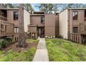 Charming condo with a landscaped front yard, walkway and brown wooden door, creating a warm welcome at 5316 Pebble Beach Dr # E, Orlando, FL 32811