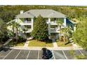 Condo exterior showcasing multiple units with private balconies and lush landscaping at 608 Gran Bahama Blvd # 608, Davenport, FL 33897
