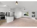 Bright living room open to the kitchen, featuring a breakfast bar, stainless steel appliances, and plenty of natural light at 3623 Worth Cir, The Villages, FL 32162