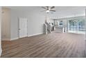 Bright, open-concept living area with hardwood floors and a ceiling fan at 1106 Presidential Ln, Apopka, FL 32703