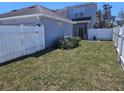 Spacious backyard with a well-kept lawn and white privacy fence at 14053 Wild Majestic St, Orlando, FL 32828