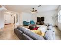 Spacious living room with gray sectional sofa and two teal armchairs at 2399 Parkside Glen Dr, Apopka, FL 32712