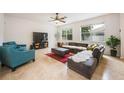 Open living area featuring a large sectional sofa and a flat-screen TV at 2399 Parkside Glen Dr, Apopka, FL 32712