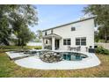 Inviting kidney-shaped pool with a stone waterfall feature in the backyard at 2399 Parkside Glen Dr, Apopka, FL 32712