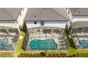 Aerial view of a backyard with screened-in pool, landscaping, and patio furniture, perfect for outdoor enjoyment at 6240 Sand Skipper Rd, Orlando, FL 32821