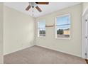 Bright bedroom with neutral carpet, ceiling fan, and windows providing ample natural light at 13228 Daniels Landing Cir, Winter Garden, FL 34787