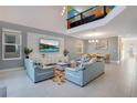 Spacious living room with vaulted ceiling and large TV at 571 Drop Shot Dr, Davenport, FL 33896