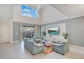 Bright living room with vaulted ceiling, TV and access to pool at 571 Drop Shot Dr, Davenport, FL 33896