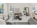 Bright and airy living room featuring modern furnishings, neutral tones, and a view to the outdoor area at 813 S Locust Ave, Sanford, FL 32771
