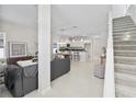 Open-concept living space with stairs, modern kitchen, and stylish furnishings with an abundance of natural light at 813 S Locust Ave, Sanford, FL 32771