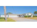 Charming single-story home featuring a two-car garage, well-maintained landscaping and a long private driveway at 136 Reef Rd, South Daytona, FL 32119