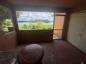 Enclosed patio offering a tranquil view of the lake at 4008 Versailles Dr # 4008C, Orlando, FL 32808