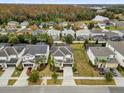 A scenic aerial view of the community and the surrounding area with mature trees and lake at 4501 Monado Dr, Kissimmee, FL 34746
