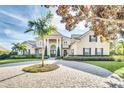 Grand two-story home with circular driveway and manicured landscaping at 9664 Weatherstone Ct, Windermere, FL 34786