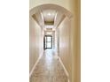 Inviting foyer with a tiled floor, neutral walls, and arched entryway leading into the home at 15531 Waterleigh Cove Dr, Winter Garden, FL 34787