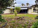 House with a walkway and small palm tree in front at 22711 State Road 44, Eustis, FL 32736