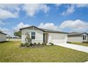 Charming one-story home featuring a well-kept lawn and a two-car garage, perfect for a Gathering at 1337 Oak Valley Dr, Auburndale, FL 33823