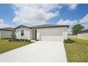 Attractive one-story home with a pristine driveway, a two-car garage, and a well-maintained lawn at 1337 Oak Valley Dr, Auburndale, FL 33823
