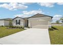 Charming single-story home featuring a two-car garage and well-maintained front yard at 1341 Oak Valley Dr, Auburndale, FL 33823