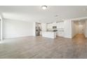 Bright, open-concept living space featuring tile flooring and a modern kitchen at 1341 Oak Valley Dr, Auburndale, FL 33823
