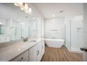 Luxurious bathroom with soaking tub, walk-in shower, and double vanity at 686 Creeping Fig St, Apopka, FL 32703