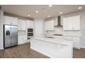 Modern kitchen with white cabinets, stainless steel appliances, and an island at 686 Creeping Fig St, Apopka, FL 32703
