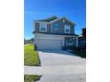 Attractive two-story home displaying a manicured lawn, a convenient two-car garage, and a welcoming facade at 247 Villavista Ct, Davenport, FL 33896