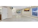 Open concept living room with tile floors, a front door entrance and natural light streaming through windows at 9517 Brackin St, Orlando, FL 32825